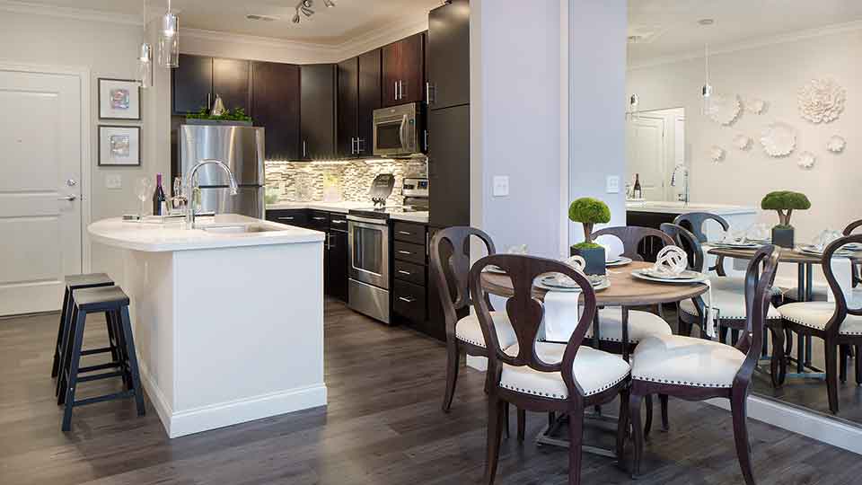 Open-concept kitchen layout with white quartz countertops and wood-grained flooring.