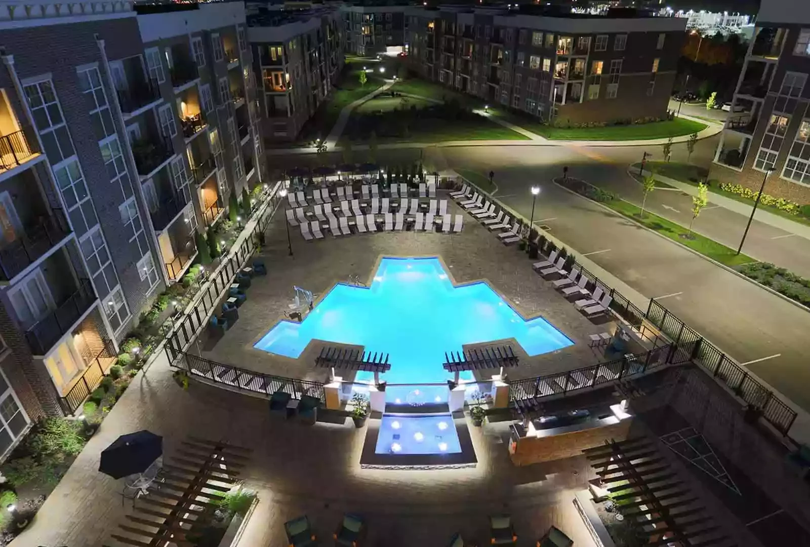 Aerial view of a geometric pool and expansive party deck at Allure.