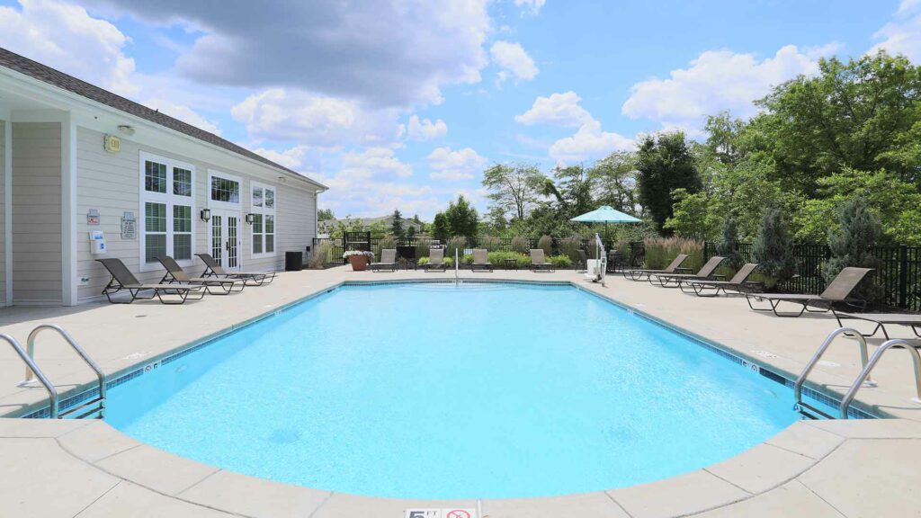 Outdoor pool with lounge chairs at Brinley Place.