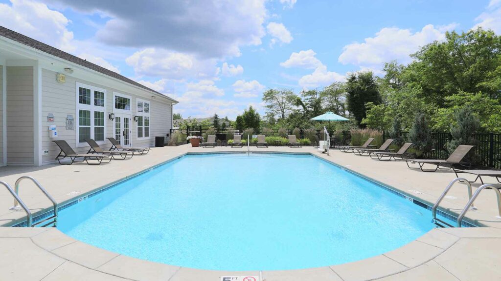 Outdoor pool with lounge chairs at Brinley Place.