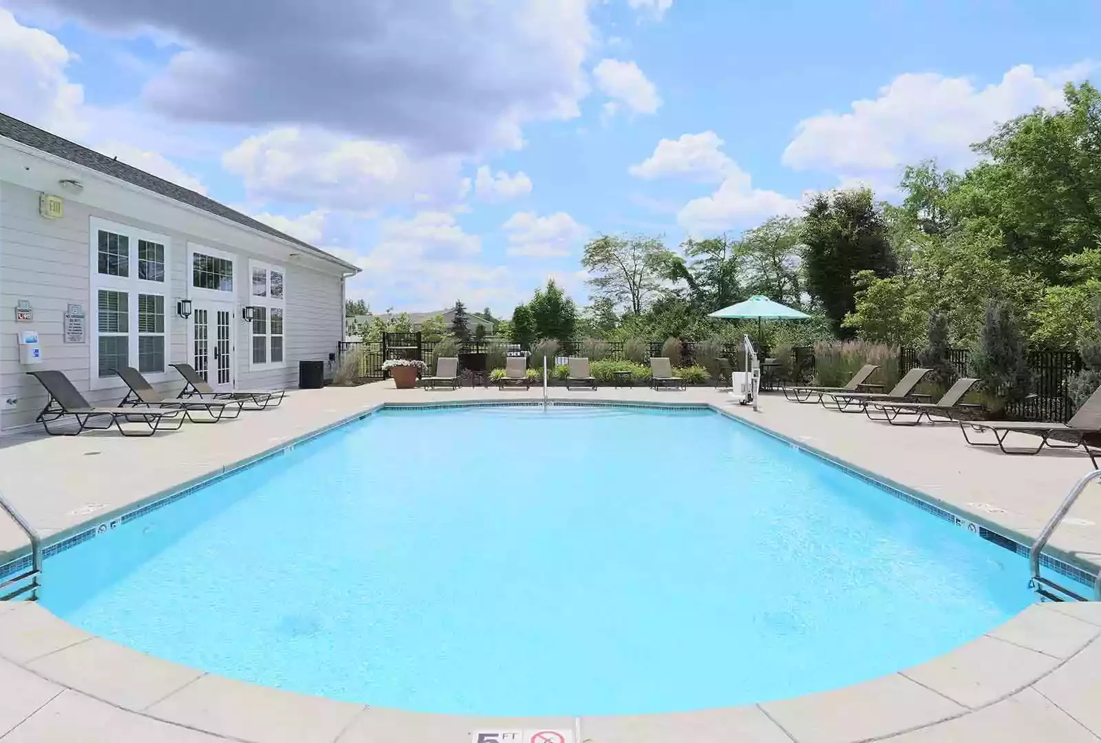 Outdoor pool with lounge chairs at Brinley Place.