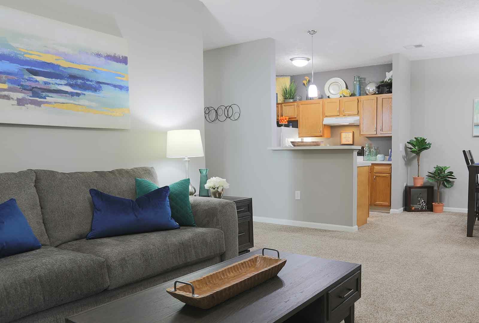 Open living room with a connected kitchen.
