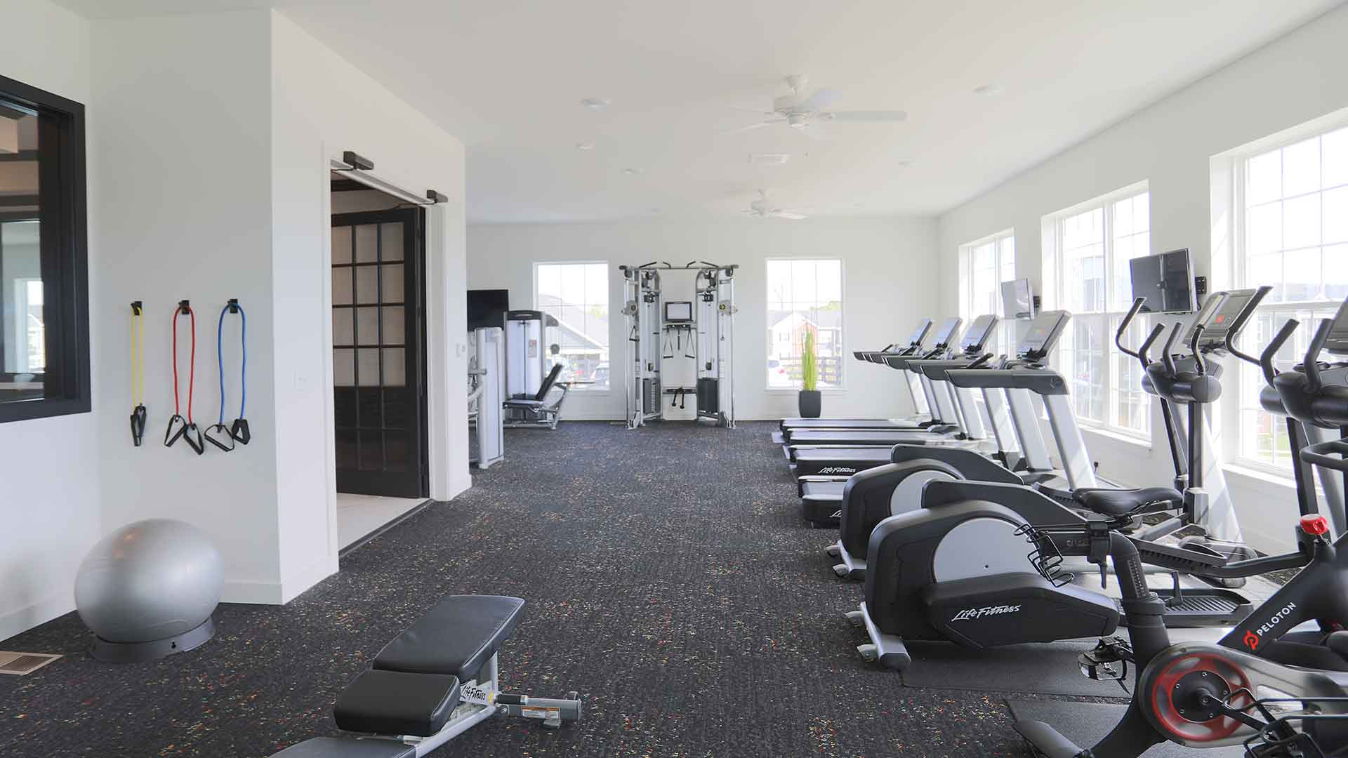 Spacious fitness center with exercise machines at Greyson on 27.