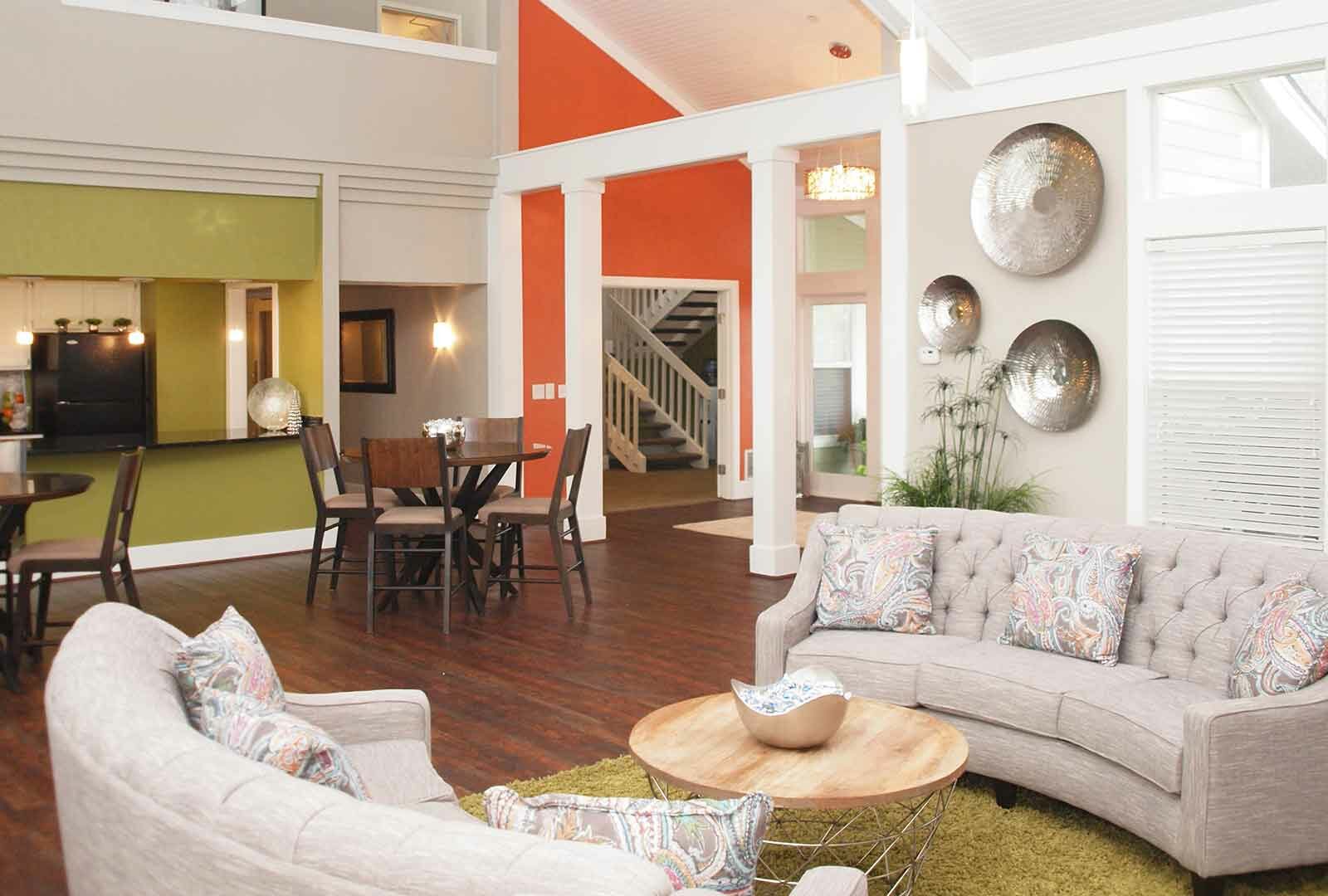 Clubhouse with two kitchen tables and sofas at Island Club Apartments.