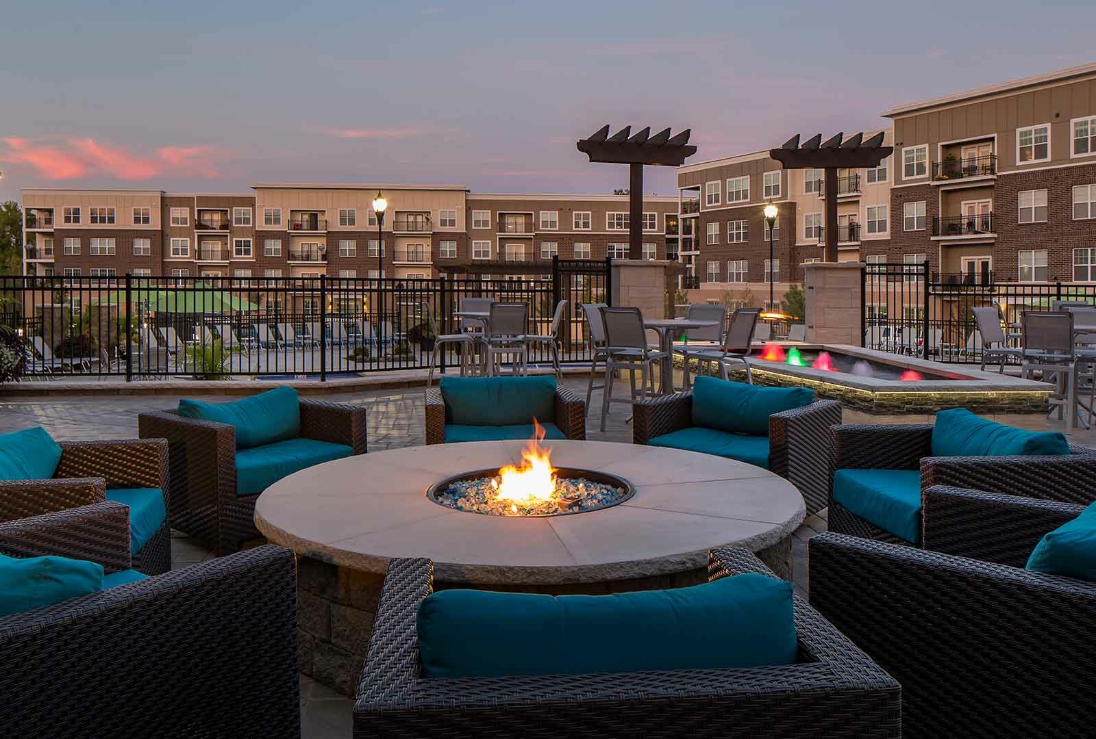 Outdoor fire pit with lounge chairs on terrace at Savoy of West Chester.