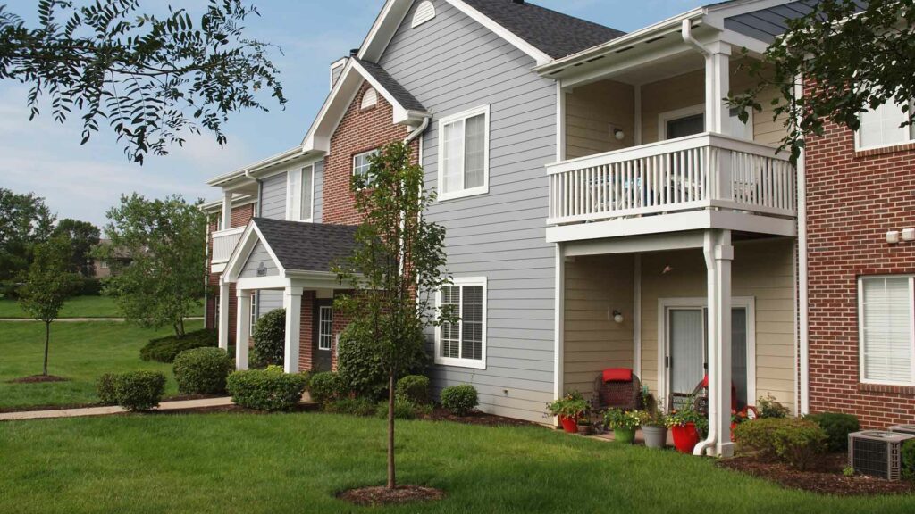 Apartment building exterior with balconies and landscaping at Shadow Ridge.