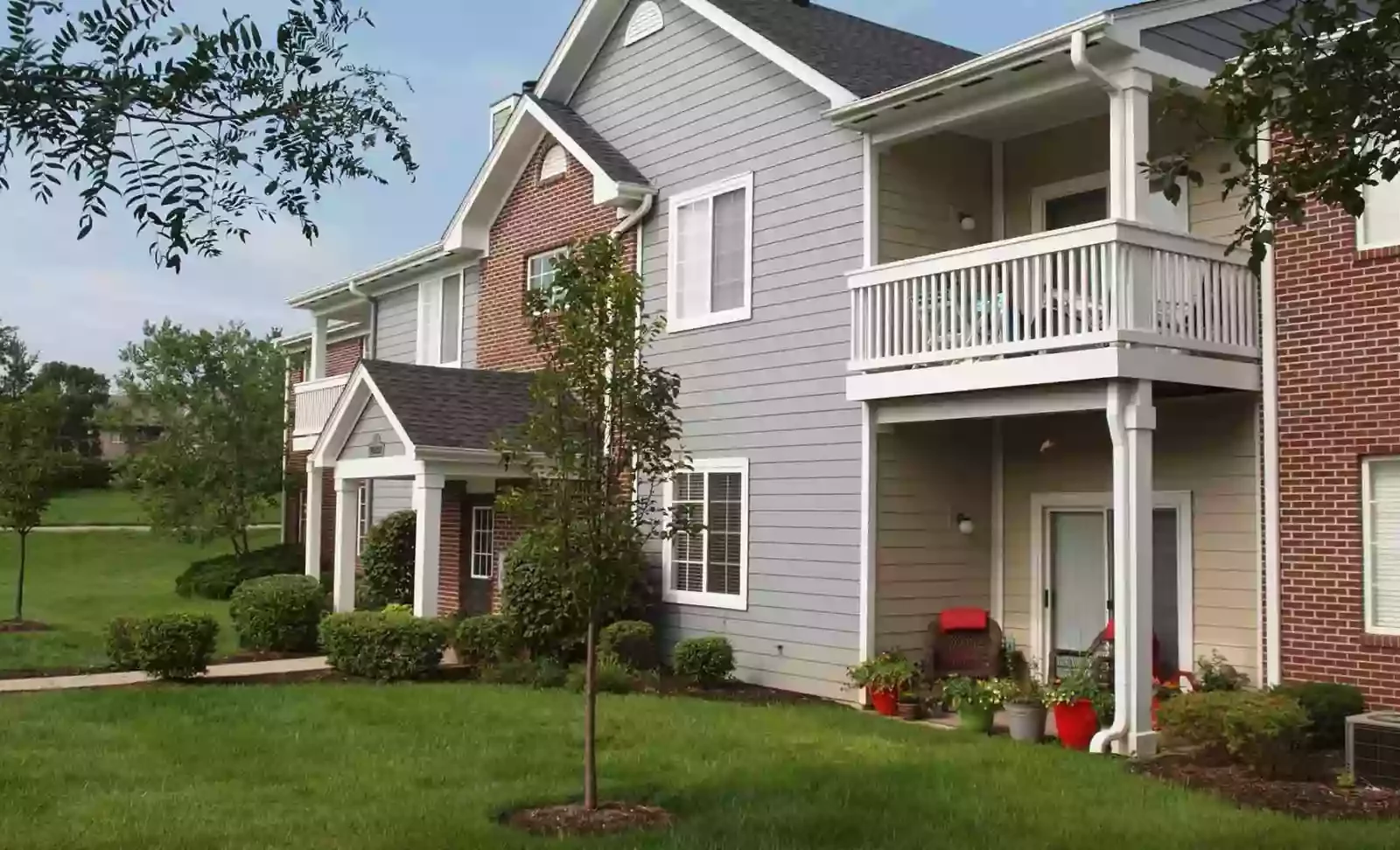 Apartment building exterior with balconies and landscaping at Shadow Ridge.