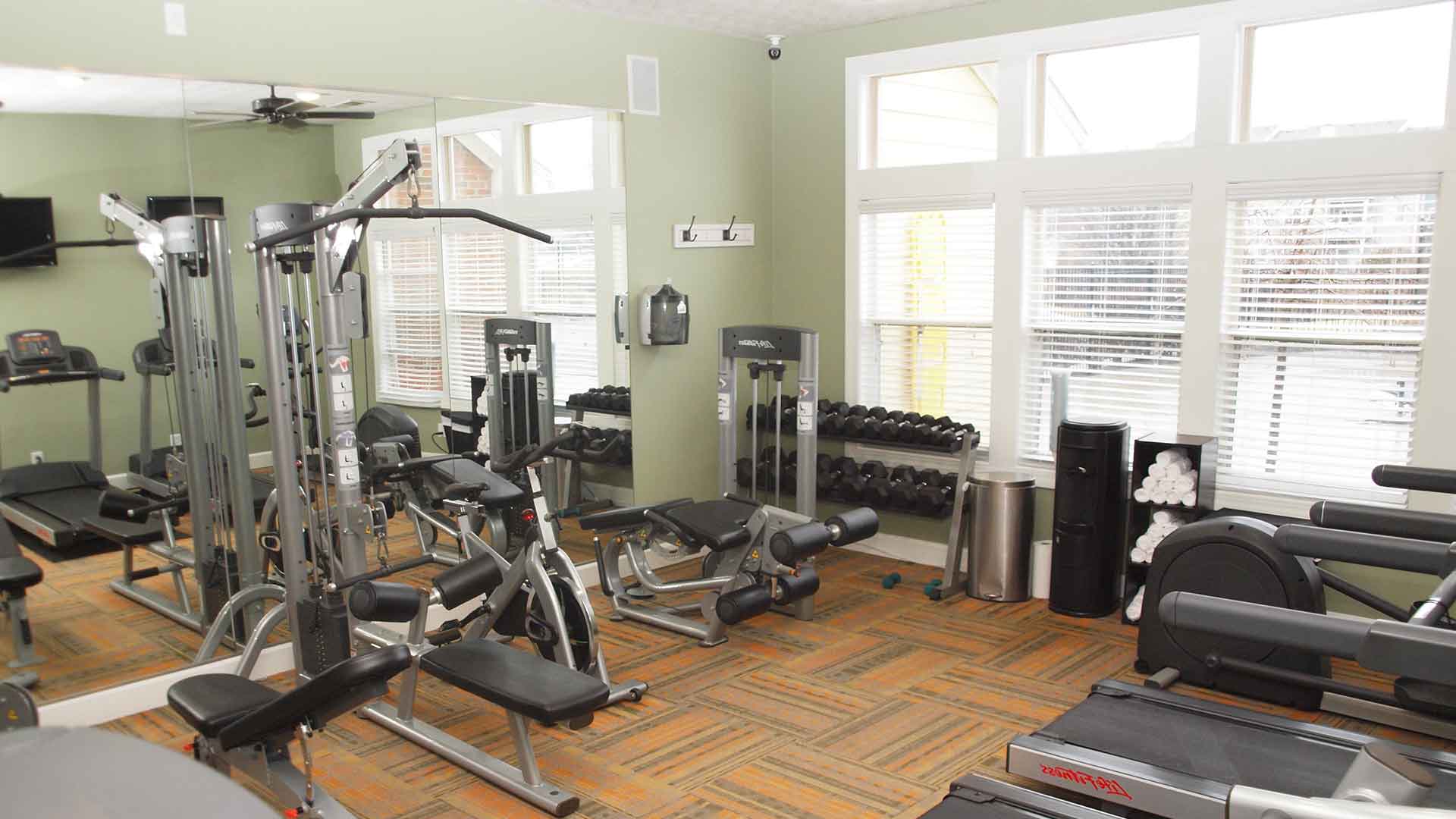 Fitness center with workout machines and free-weights at Waterford Place.