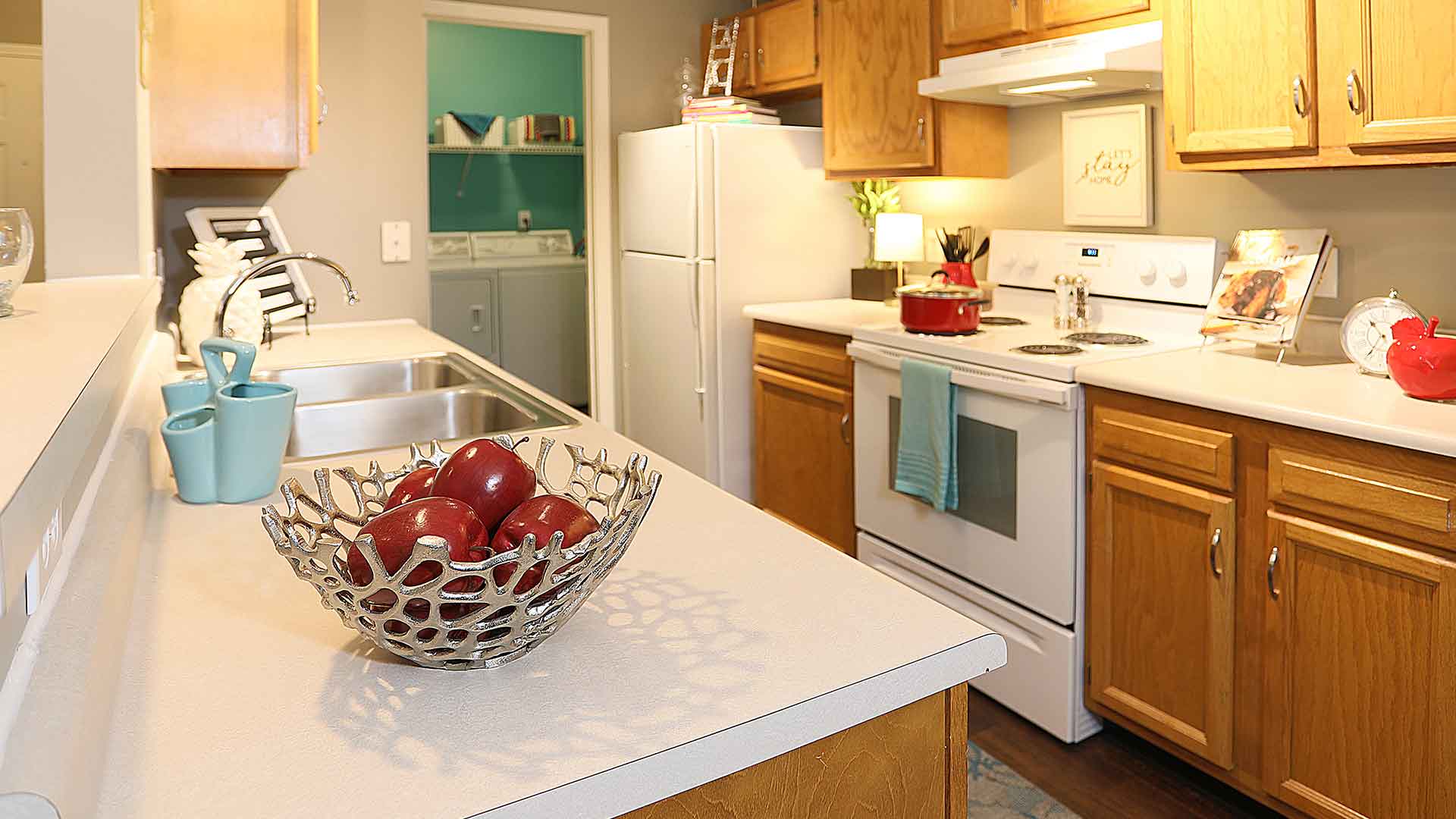 Decorated kitchen and adjacent laundry area at Wellington Place.