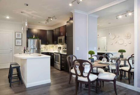Open-concept kitchen layout with white quartz countertops and wood-grained flooring.