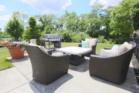 Patio furniture and electric grill outdoors.