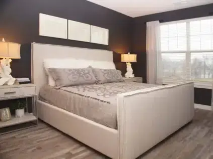 Spacious bedroom furnished with a queen sized bed.