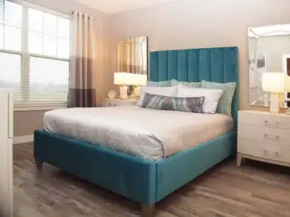 Bedroom with wood flooring and bedroom furniture.