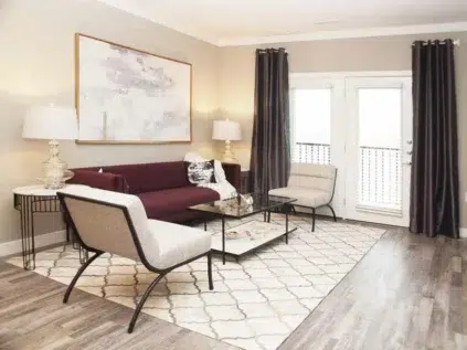 Living room space with wood-grain flooring at Element Oakwood.