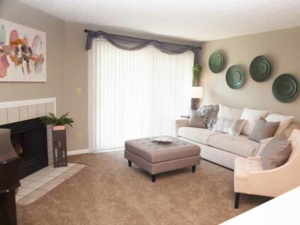 Decorated living room with fireplace at Fox Chase North.