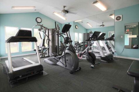 Fitness center with exercise machines and Peloton bike at Fox Chase North.