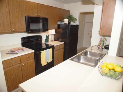 Apartment kitchen with ample counter space and cabinetry.