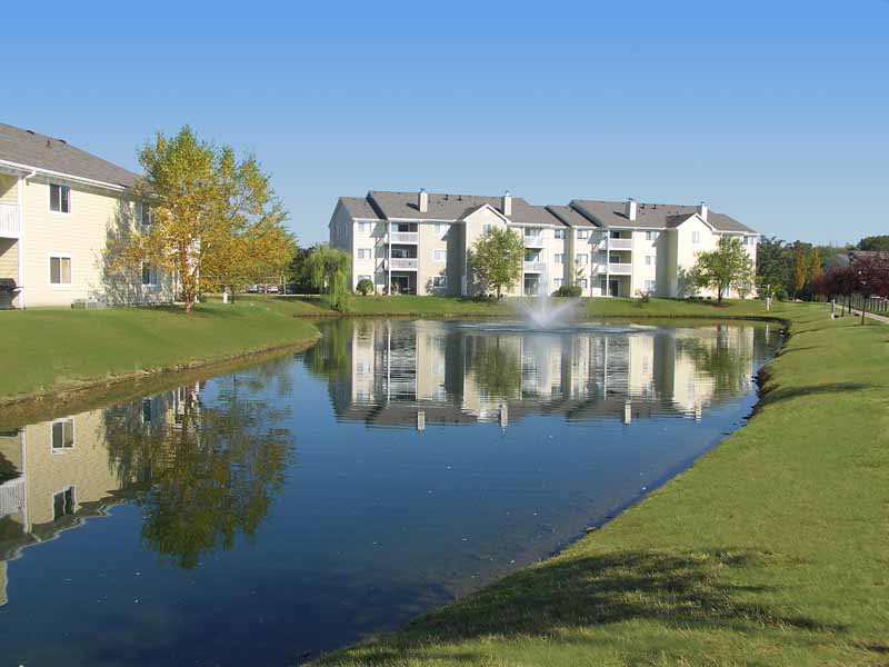 Island Club Apartment buildings surrounded by a small lake.