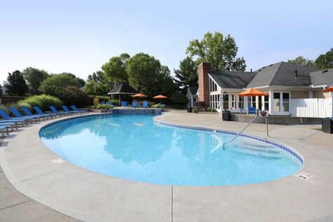 Outdoor pool with lounge deck and chairs at Fox Chase North.