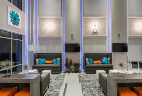 Modern resident area with TVs and seating areas.