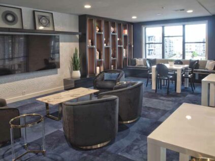 Decorated clubhouse lounge area with a TV at Allure.
