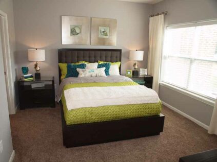 Carpeted bedroom with bedroom furniture.