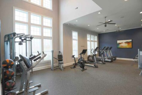 Open fitness room with gym equipment.