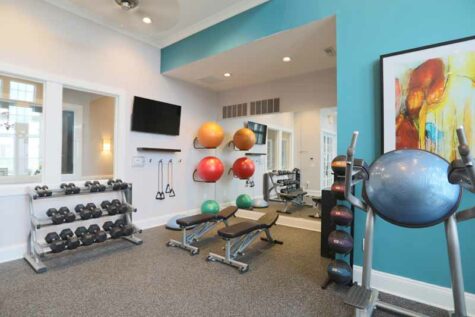 Fitness room with free weights and exercise accessories.