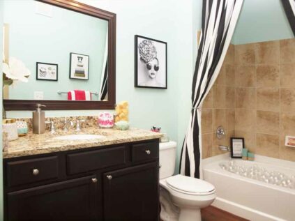 Bathroom with ample counter space and a combination tub and shower.