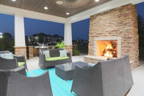 Community fireplace with comfortable furniture in the evening.