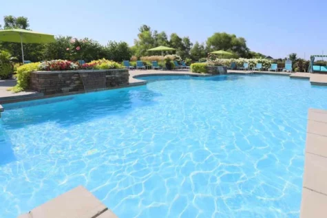 Community saltwater swimming pool with waterfall features.