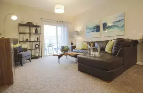 Decorate living room with sliding screen door out to patio.