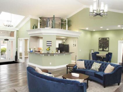 Decorated clubhouse lounge area with kitchen at Waterford Place.