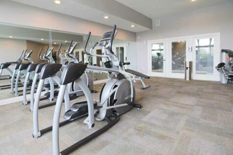 Fitness center with exercise machines at Wellington Place.