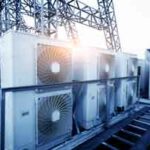 Air conditioner units on a roof of an industrial building.