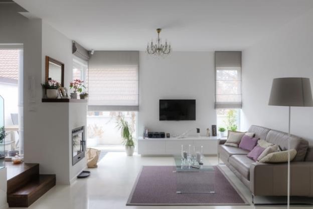 Airy sitting space with TV mounted adjacent to the fireplace