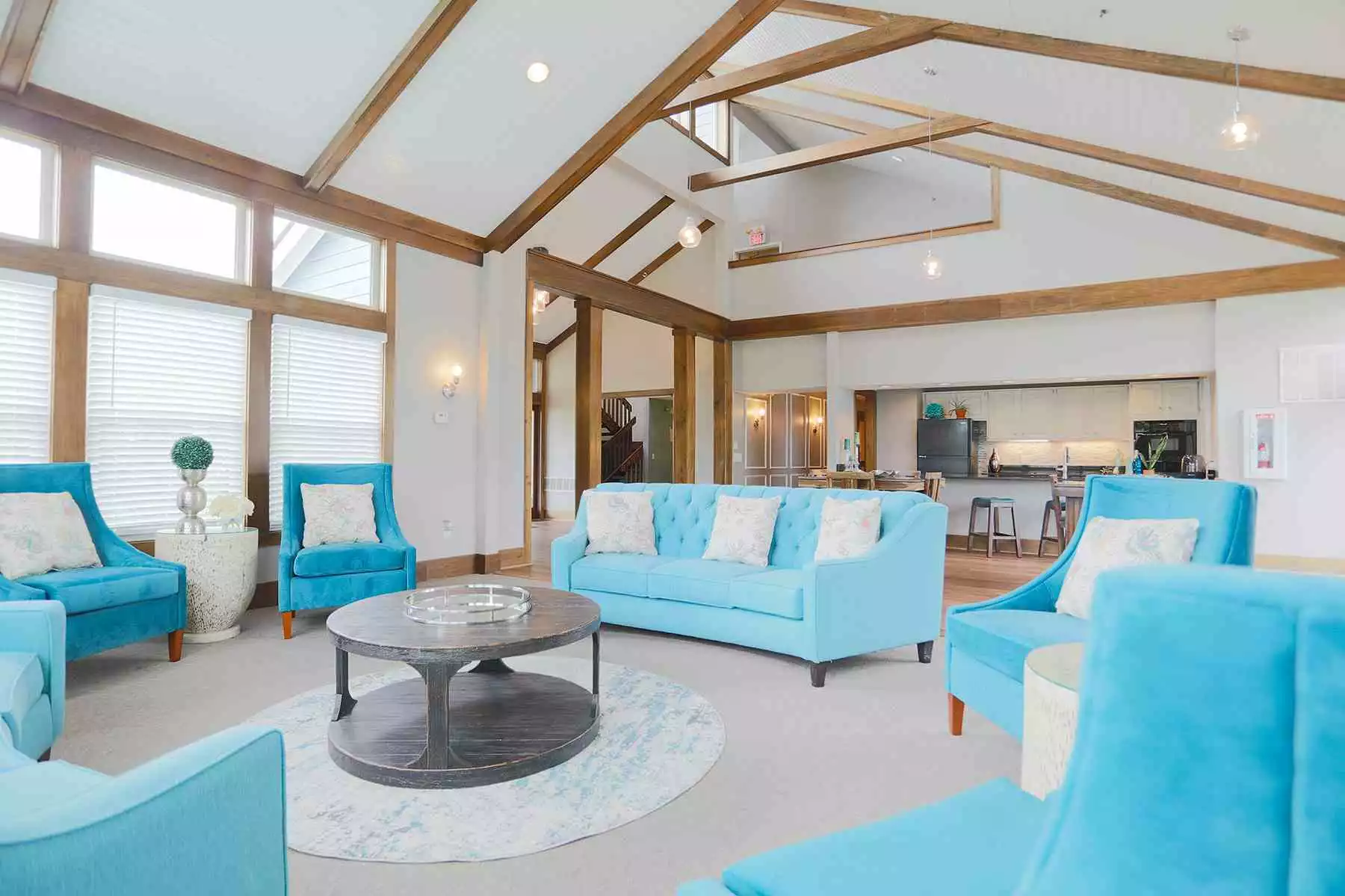 Bright blue couch and chairs in Mallard Landing apartment office building.