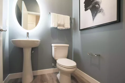 A clean and modern bathroom featuring a self-illuminated mirror.