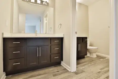 Bathroom at The Landings at Beckett Ridge. Two vanities, mirror and toilet