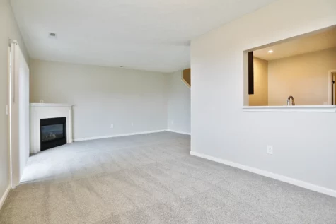 Empty floor plan at The Landings at Beckett Ridge. Spacious living space, fire place and opening to kitchen area