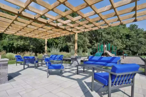 Fox Chase North's social deck, featuring outdoor seating and paved walkways.