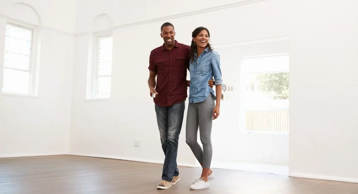 A couple walking in to their new apartment