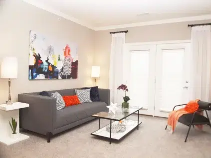 Allure apartments living room area, Couch, glass coffee table and chair