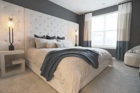 Rialto bedroom with large bed, modern backboard, side table