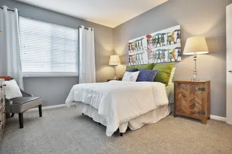 Shadow Ridge bedroom. Double bed, nightstand artwork and chair