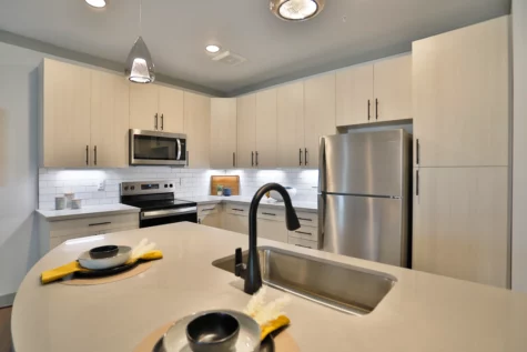 Graphite Oakley Apartments modern, new kitchen area. White countertops, walls and cabinets