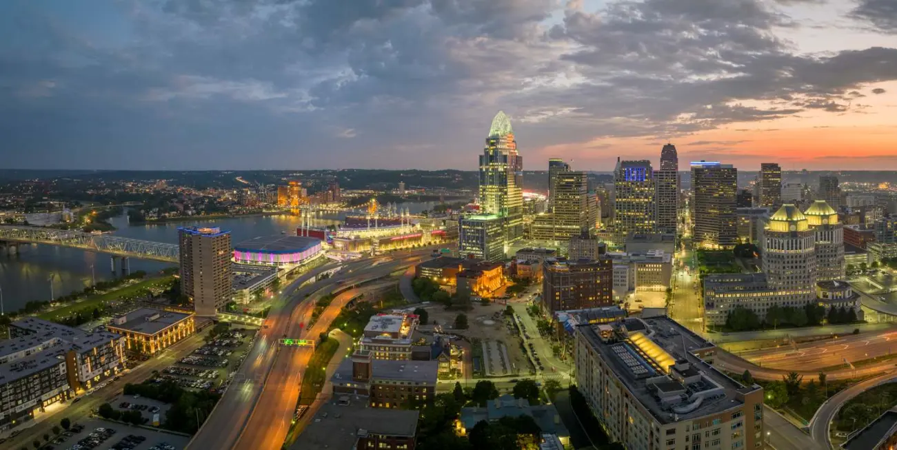 The Cincinnati, OH, city skyline and urban landscape lit up at night.