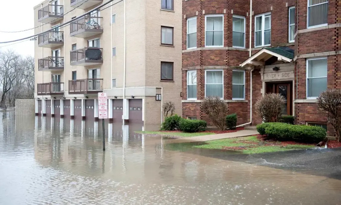 A view of floodwaters rising outside of apartment buildings.