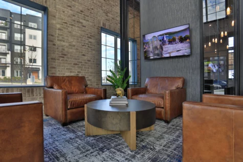 Clubhouse at Graphite Oakley in Cincinnati, OH. Leather chairs, table and tv.