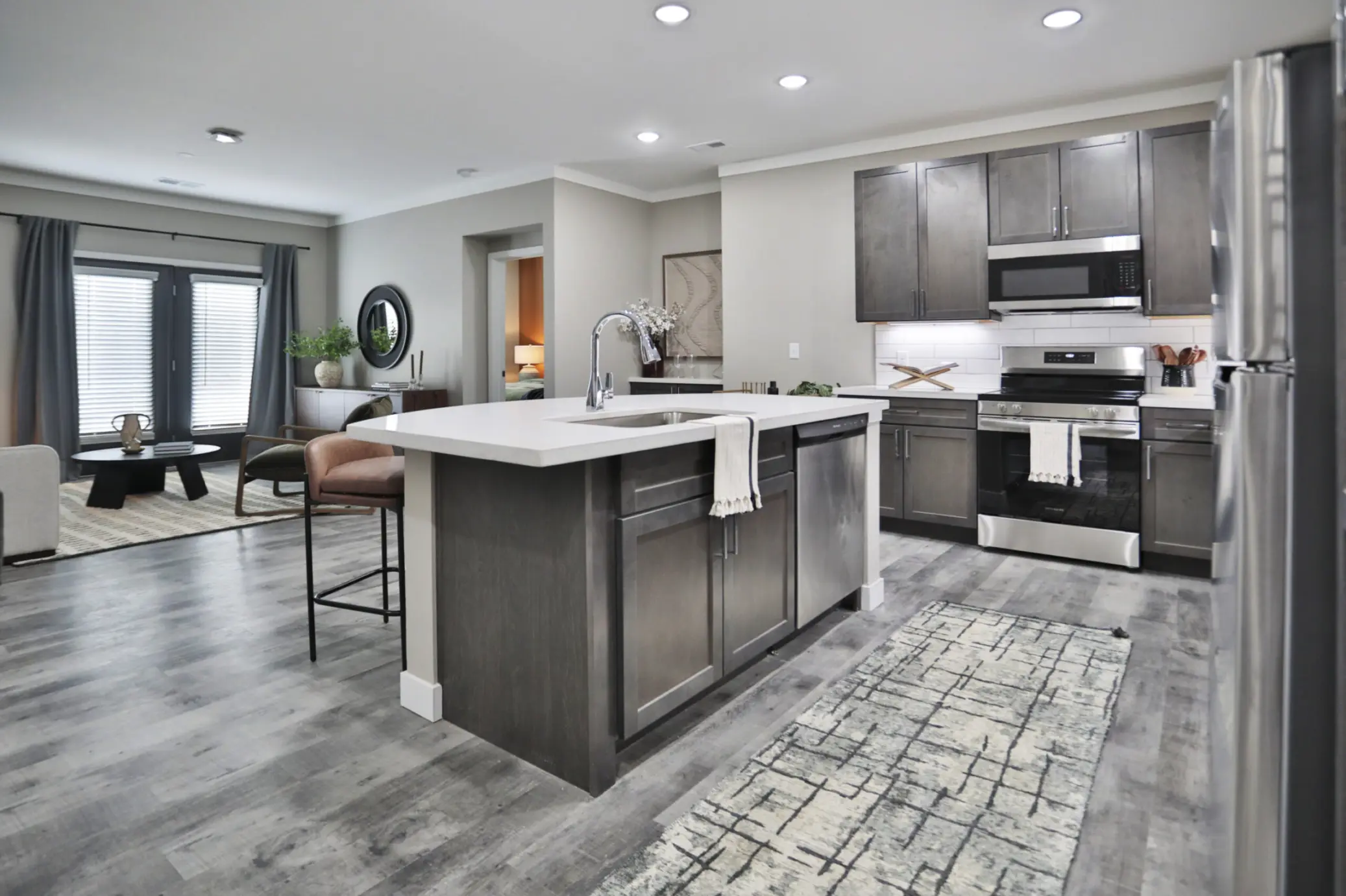 Model 4 option at Altair Apartments in Florence, KY. Kitchen and Living area with upscale kitchen, over and microwave.